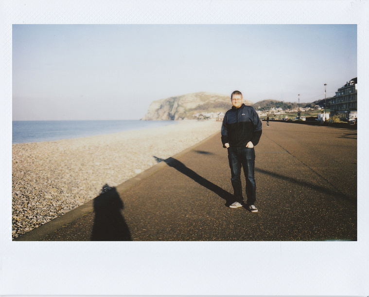 Man In Black Jacket Standing Near The Beach